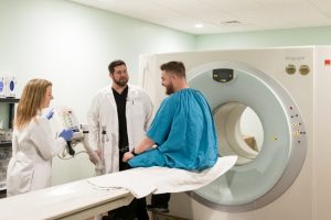 A patient talking with his doctor before having a scan