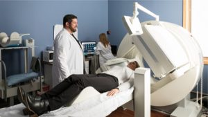 A patient talking with a doctor before a nuclear imaging scan.